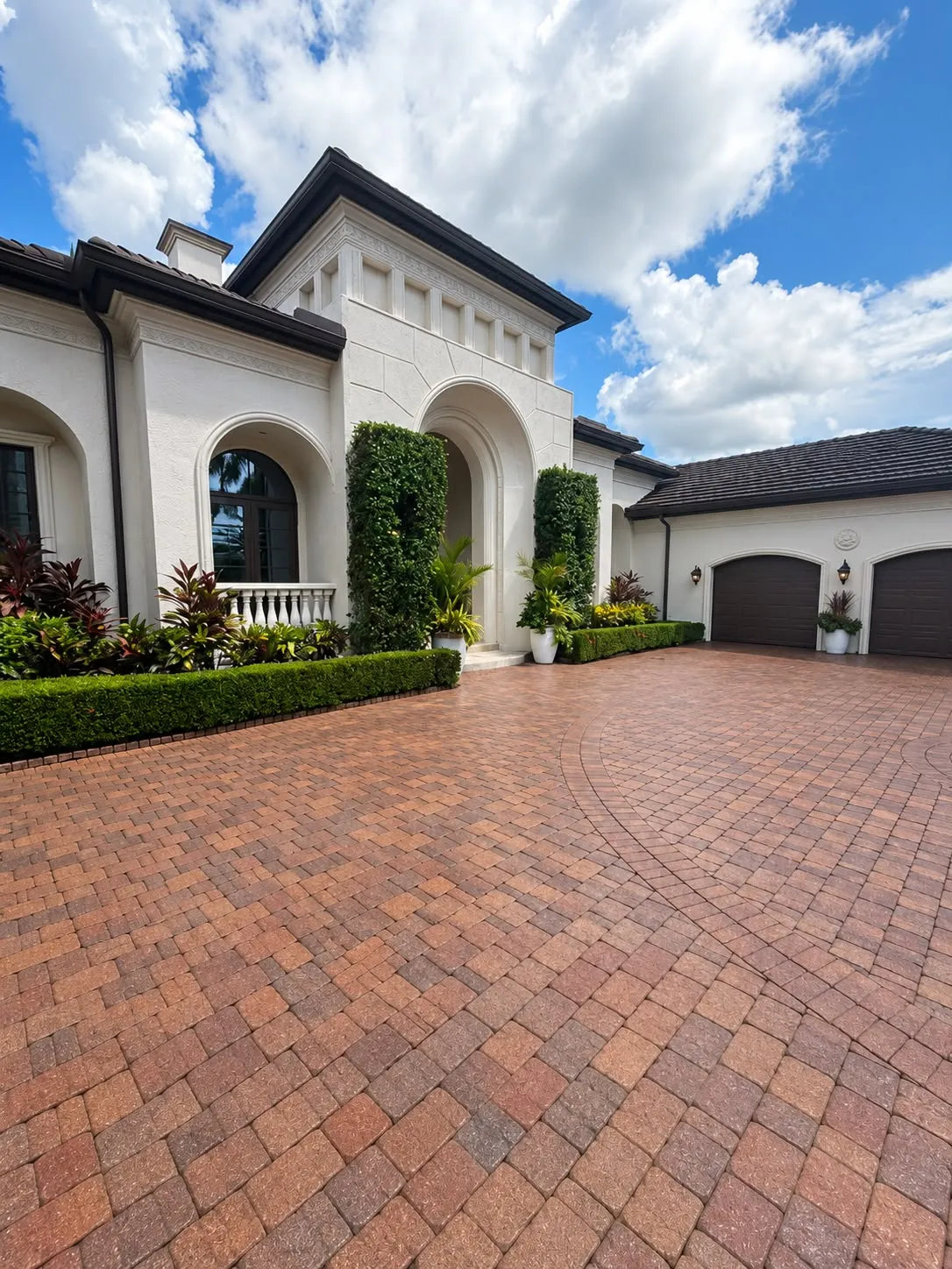 Finished paver driveway in front of a white Mediterranean-style home in Southwest Florida